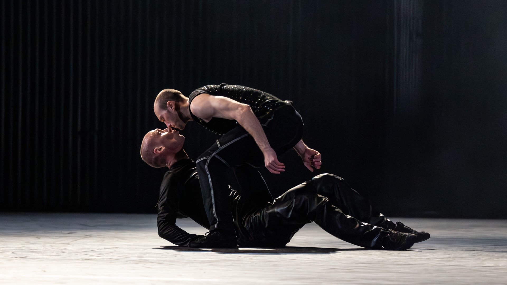 A couple of people that are sitting on the stage.