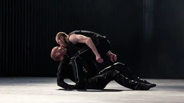 A couple of people that are sitting on the stage.