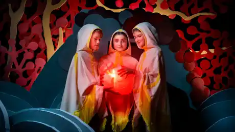Three children in caps are holding a round object that glows from within.