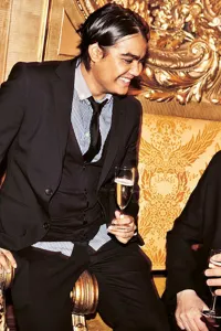 Two men and a woman are sitting next to each other.