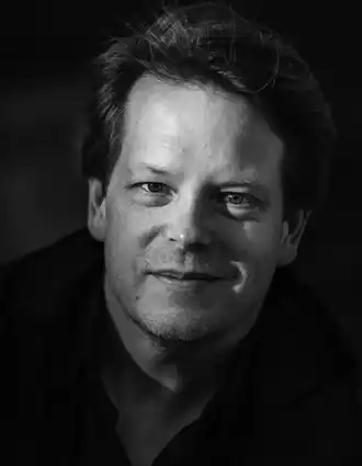 A close-up of a smiling man.