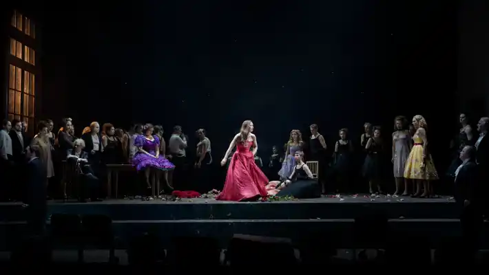 A woman in a red dress on stage.