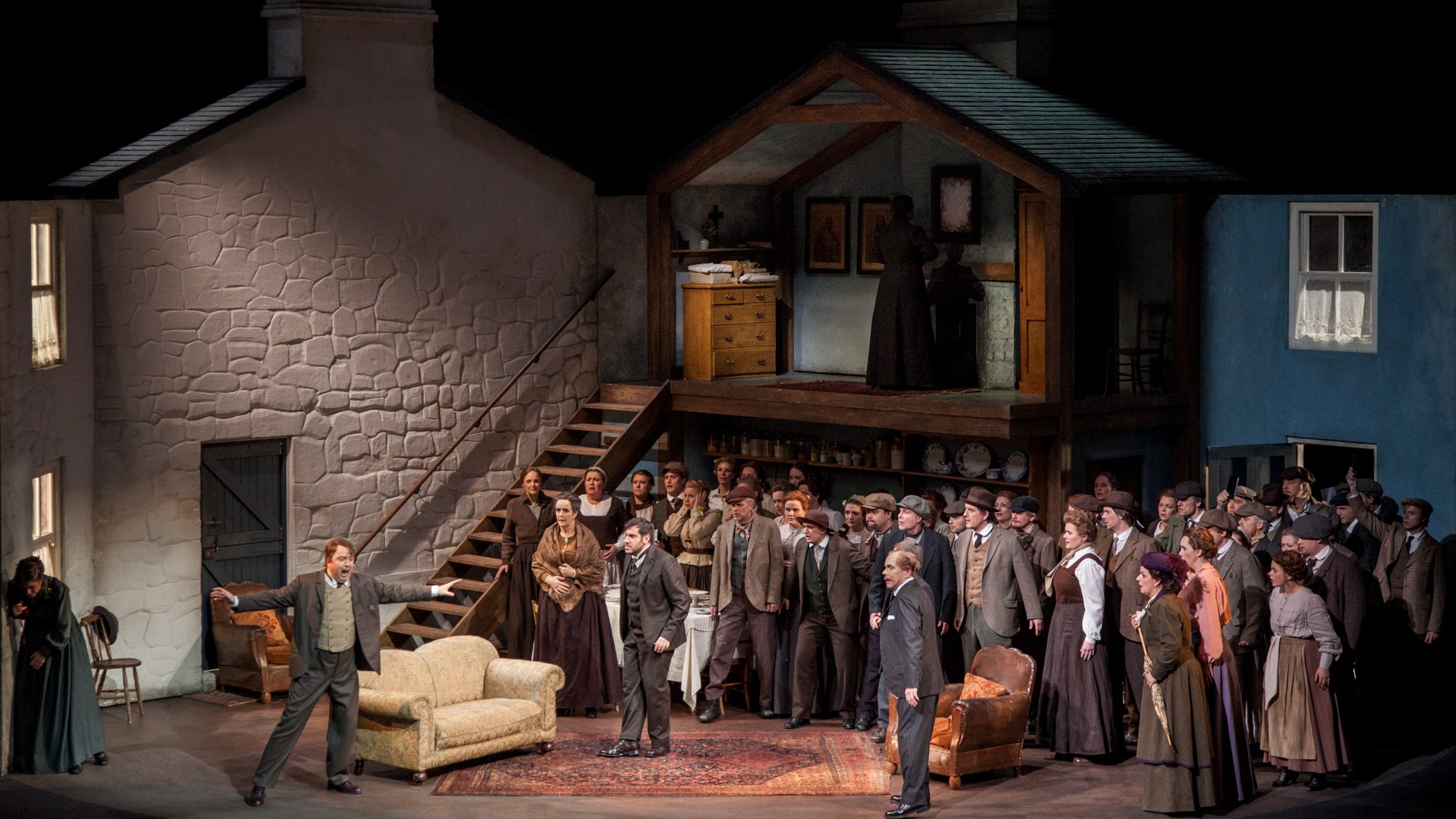 A scene with buildings in the background, in the foreground a large group of people.