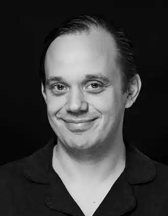 A close-up of a smiling man.