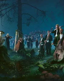 A large group of musicians standing and sitting in a forest landscape.