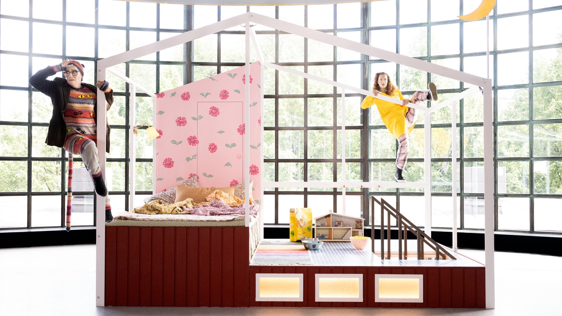 Two people climb a house-like structure.