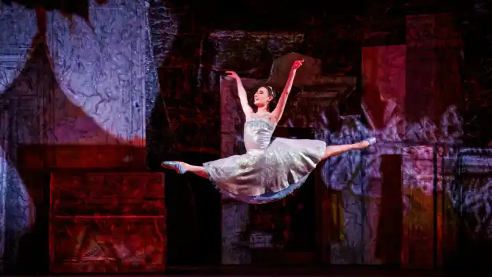 A woman in a white dress makes a big jump.