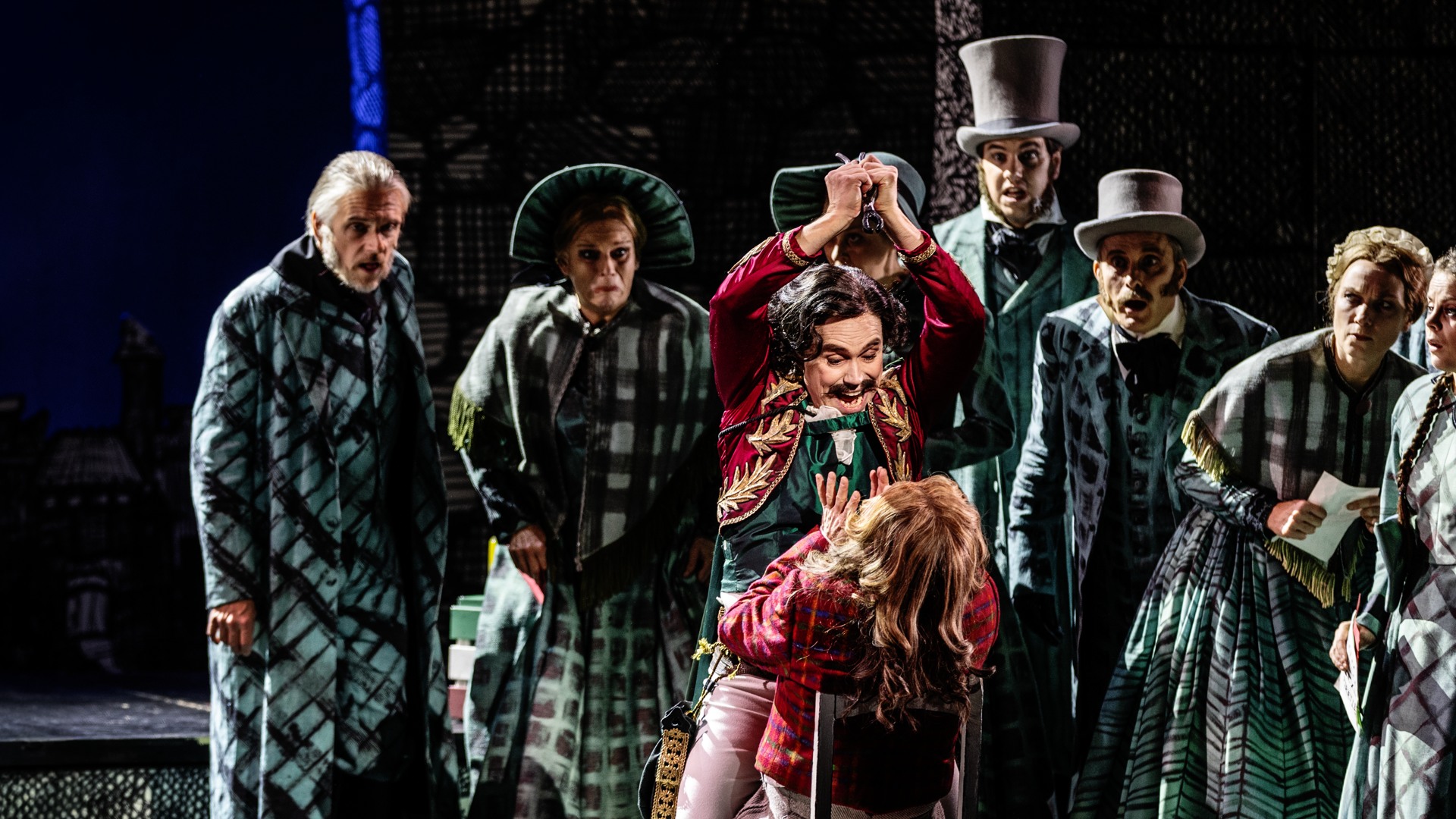 A group of people standing around each other on a stage.