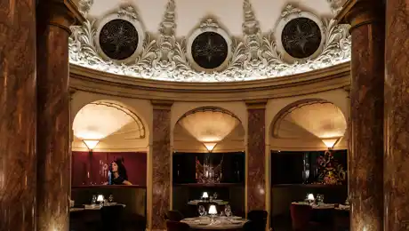 A circular, richly decorated room with alcoves.