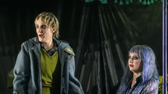 Några personer i mask och kostym på scen.