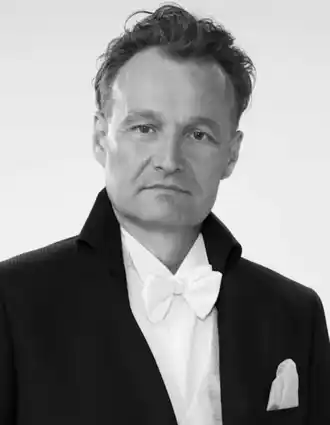 A close-up of a man wearing a tailcoat.