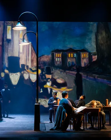 A group of people sitting around a table on a stage.