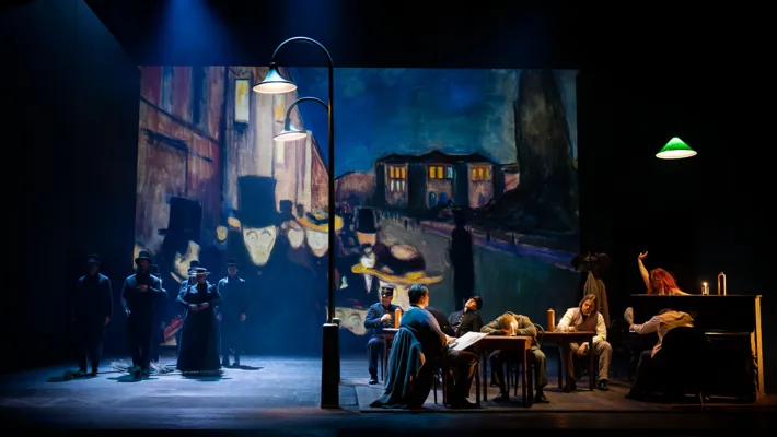 A group of people sitting around a table on a stage.